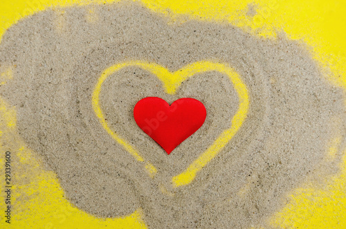 hearts on a yellow background. Heart in the sand. View from above.