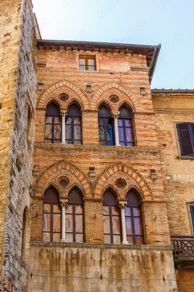 Old house facade with mullioned windows in italy