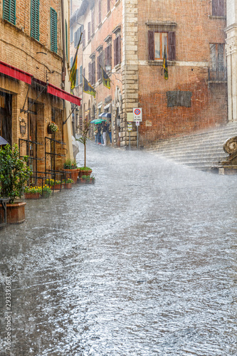 Fototapeta Naklejka Na Ścianę i Meble -  Heavy rain on a street with running rainwater