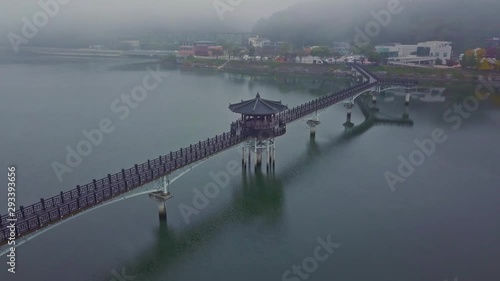 Aerial video of Wolyeonggyo bridge is located in the midst of Nakdong river in the morning during Autumn season at Andong city, South Korea. photo