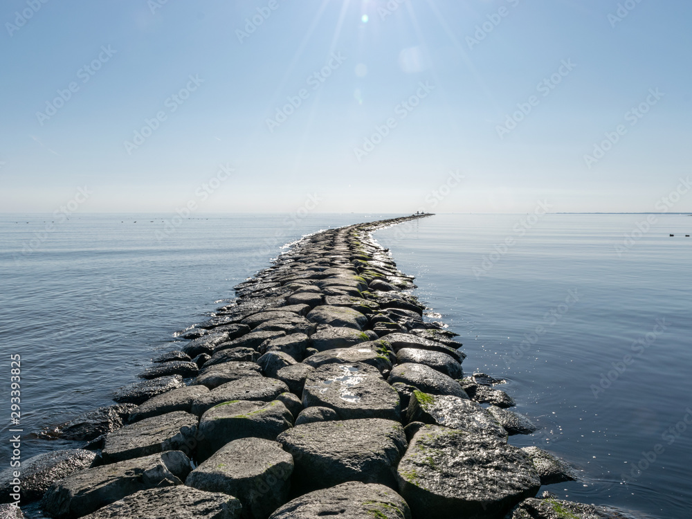landscape with stone pier in the sea, horizon line in the distance landscape with stone pier in the sea, horizon line in the distance