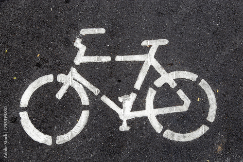 Sign bicycle on black asphalt road