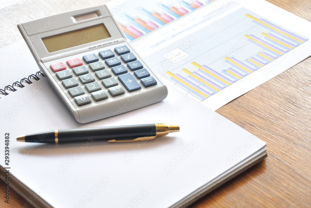 calculator and graph paper with business concept calculator and graph paper with business concept
