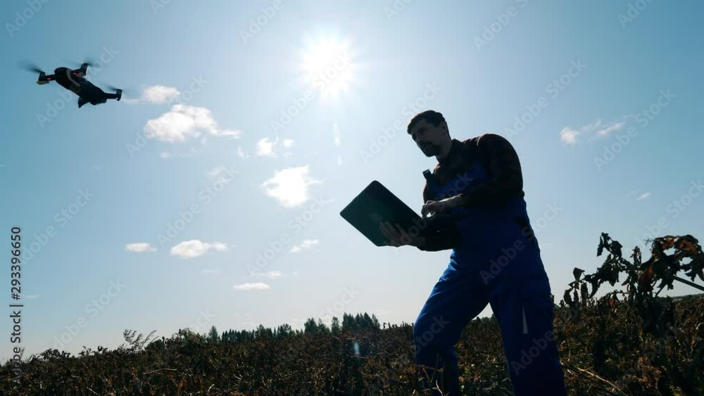 custom made wallpaper toronto digitalOne Agricultural worker uses drone while working on a field.