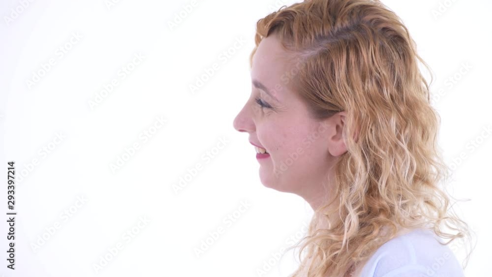 Closeup profile view of happy beautiful blonde woman smiling Closeup profile view of happy beautiful blonde woman smiling