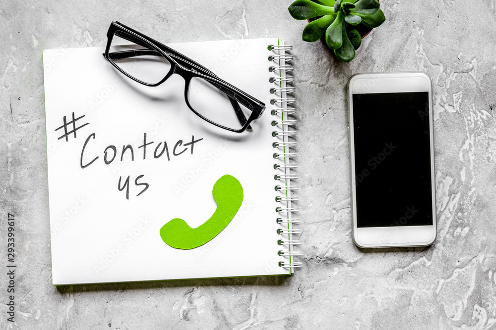 Fototapeta premium customer support service desktop with contact us signs on gray background top view