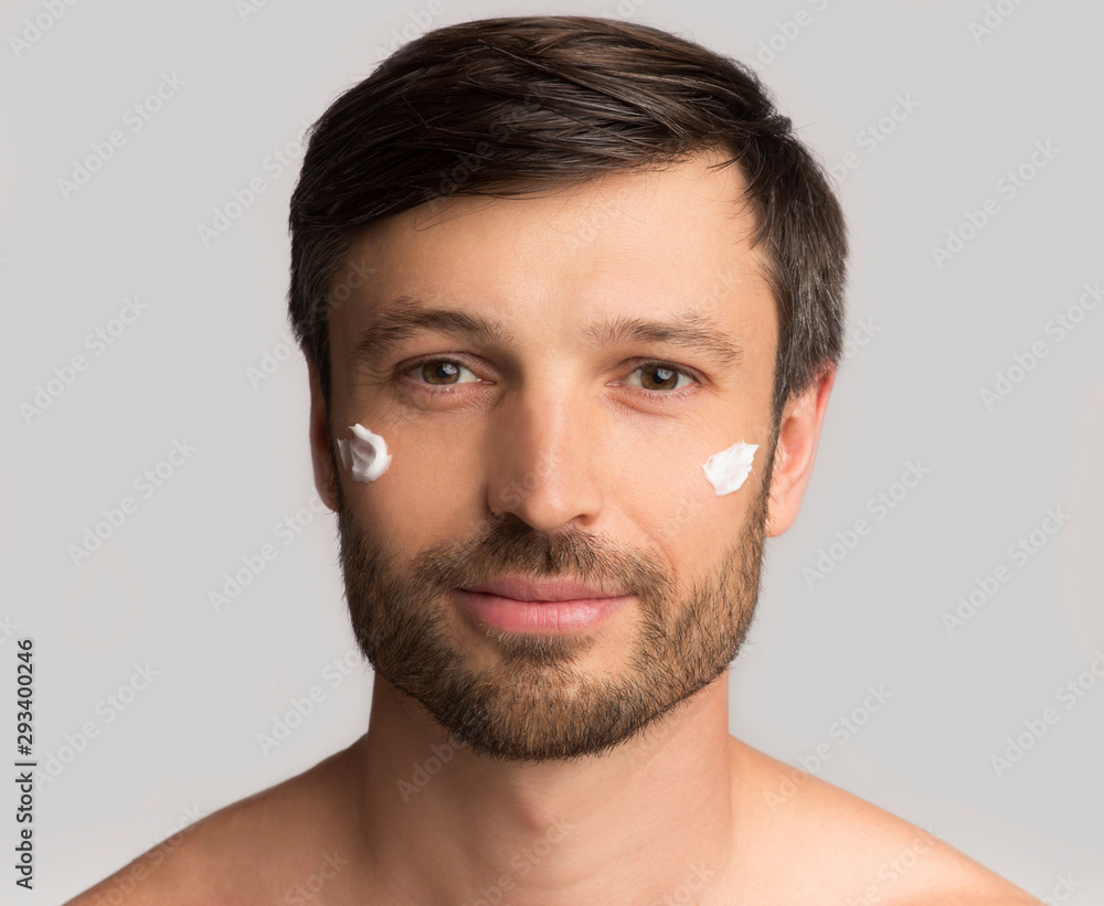 Mature Man Applying Face Cream On Skin, White Background Mature Man Applying Face Cream On Skin, White Background