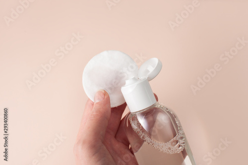 Micellar cleansing water on a cotton pad in the hand