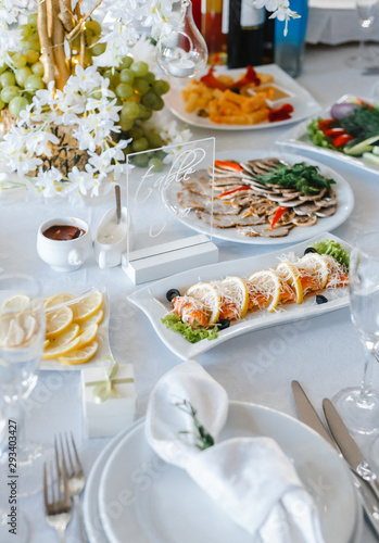 table setting with light fish and meat snacks