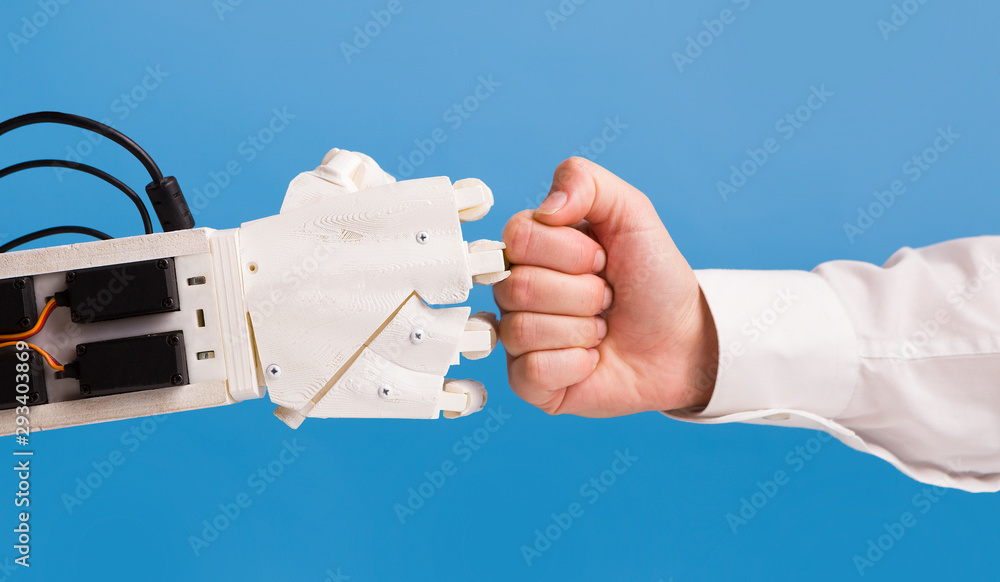 Robot and human hand making fist bump gesture Stock Photo | Adobe Stock