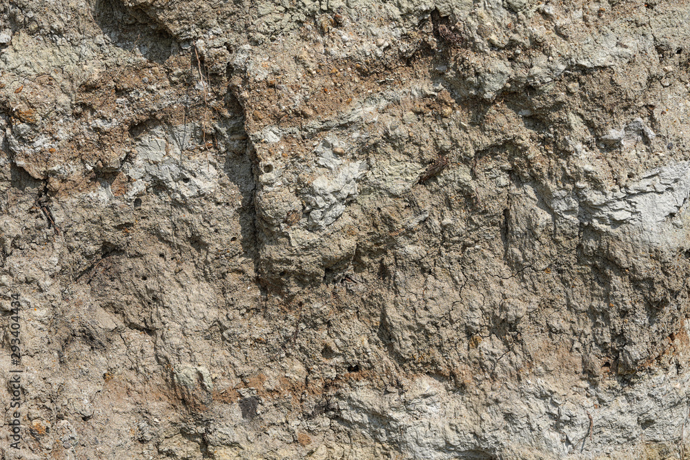 Texture of different layers of clay underground in a clay quarry. clay wall background close up Texture of different layers of clay underground in a clay quarry. clay wall background close up