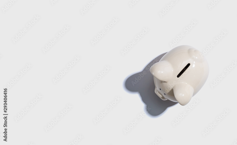 A white piggy bank overhead view flat lay A white piggy bank overhead view flat lay