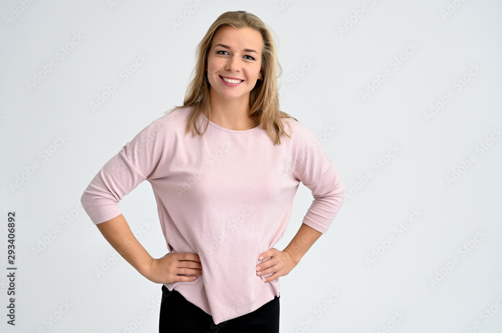 Close-up portrait of a cute caucasian blonde female student girl in pink blouse on a white background. Wide smile, happiness. It is in different poses. Close-up portrait of a cute caucasian blonde female student girl in pink blouse on a white background. Wide smile, happiness. It is in different poses.