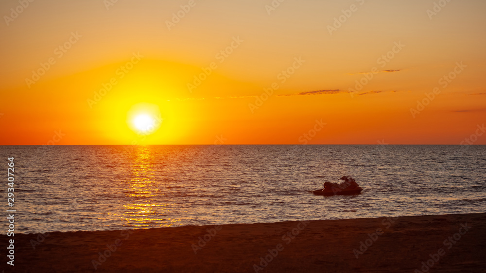Water scooter on the water surface of the Black Sea at sunset, Poti, Georgia. Water scooter on the water surface of the Black Sea at sunset, Poti, Georgia.