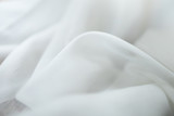 Close up of white linen cloth . Texture and fabric background or wallpaper.