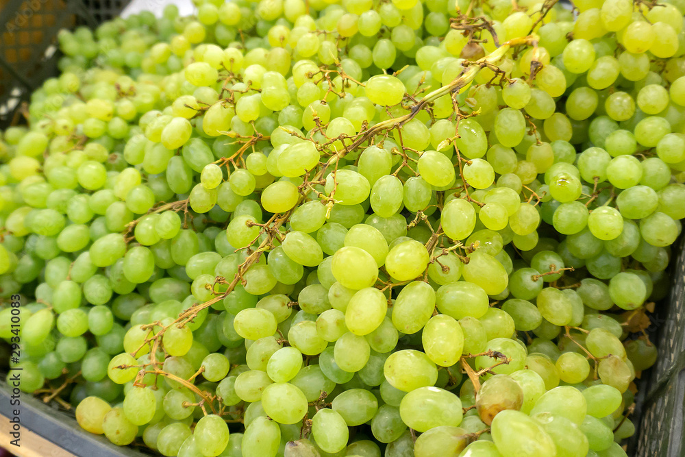 Fragrant and juicy grapes on the counter and in a wooden contain Fragrant and juicy grapes on the counter and in a wooden contain