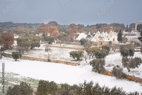 Trulli while it snows in the Apulian countryside (Italy)