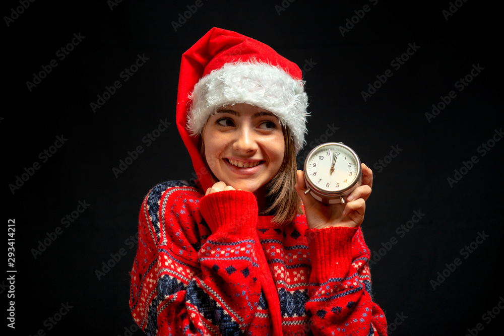 Fototapeta premium girl in Christmas dress with clock in her hand