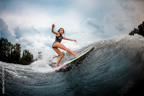 Girl wakesurfer performs stunts on a board © fesenko