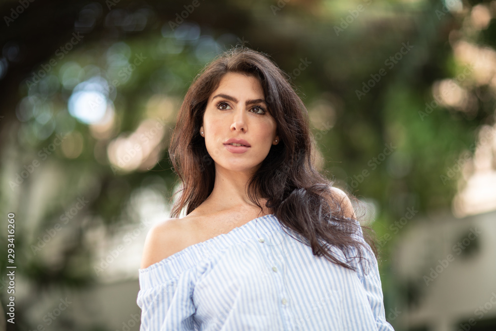 A portrait of a lovely romantic young woman outdoors, inspiringly looking forward A portrait of a lovely romantic young woman outdoors, inspiringly looking forward