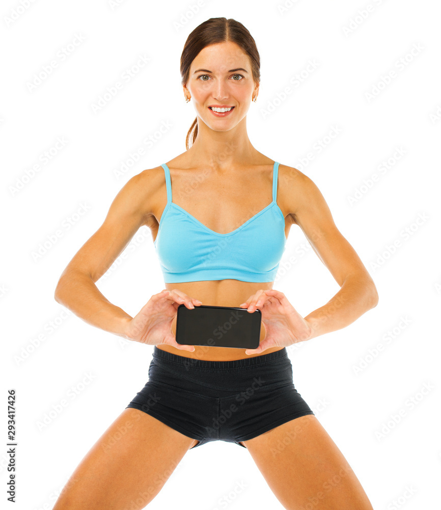 Cheerful young fitness woman showing blank smartphone screen isolated over white background Cheerful young fitness woman showing blank smartphone screen isolated over white background