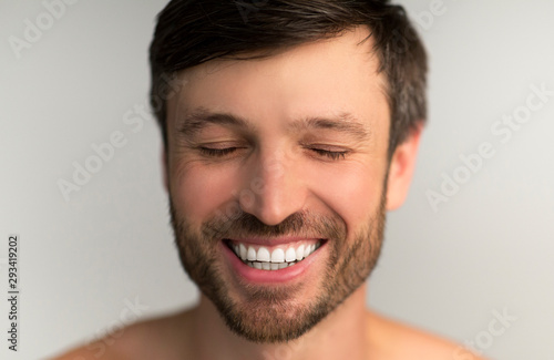 Middle Aged Man Smiling With Closed Eyes In Studio © Prostock-studio