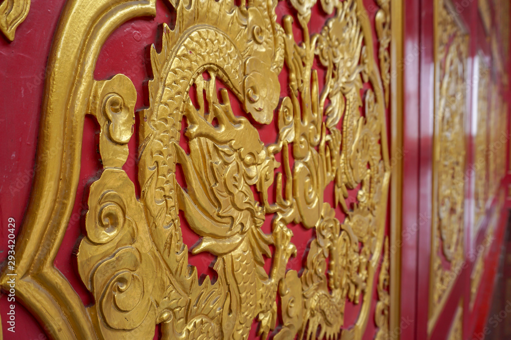 Fototapeta premium Hand crafted dragon on a wooden door