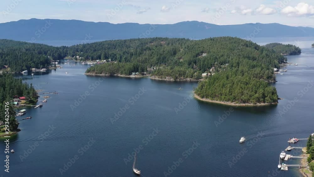 Aerial view over inlet, ocean and island with boat and mountains in beautiful British Columbia. Canada. 4K. Aerial view over inlet, ocean and island with boat and mountains in beautiful British Columbia. Canada. 4K.