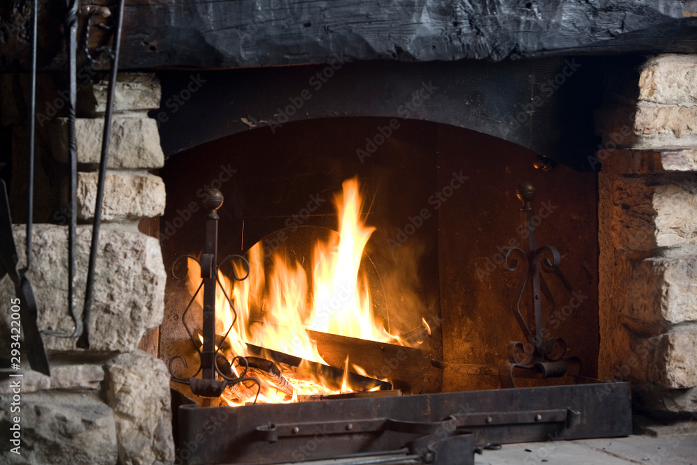 The burning fire in the fireplace warms the whole environment. The burning fire in the fireplace warms the whole environment.