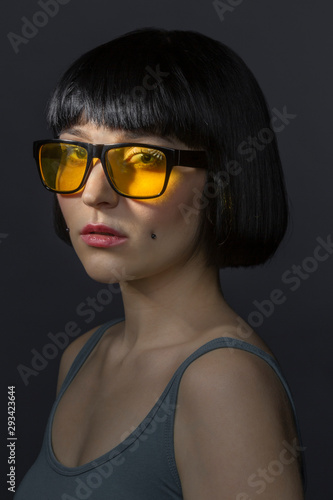 Wallpaper Mural Portrait of young woman with cheek piercing and yellow glasses Torontodigital.ca