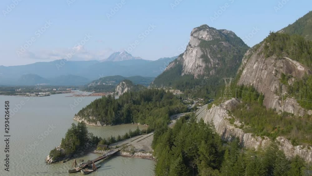 Aerial view of Sea to Sky Highway with Chief Mountain in the background during a sunny summer day. Taken near Squamish, North of Vancouver, British Columbia, Canada. Aerial view of Sea to Sky Highway with Chief Mountain in the background during a sunny summer day. Taken near Squamish, North of Vancouver, British Columbia, Canada.
