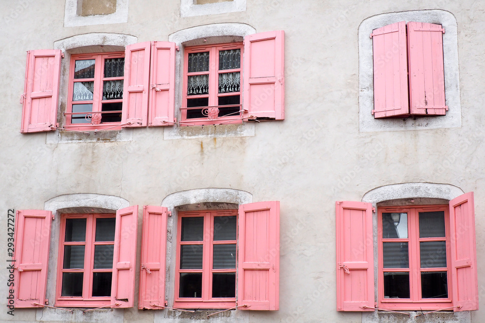 Fototapeta premium beautiful facade with pink windows and shutters