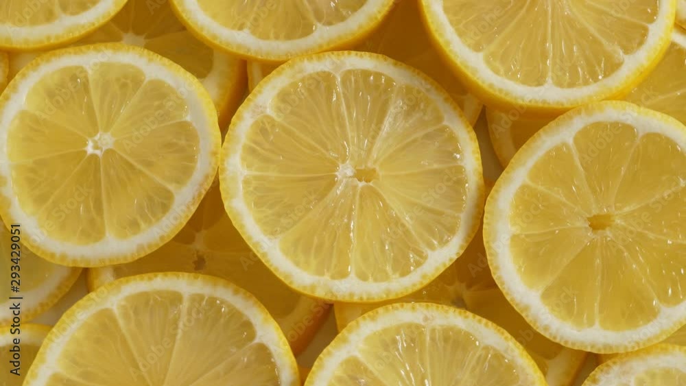 Lemon slices closeup, summer background, fruits top view. Rotate Lemon slices closeup, summer background, fruits top view. Rotate