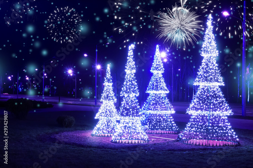 Obraz na płótnie Christmas background. Festive night city lights and decorations on the street. Lighting on Christmas scenery tree, snow and firework. Xmas and New Year w salonie