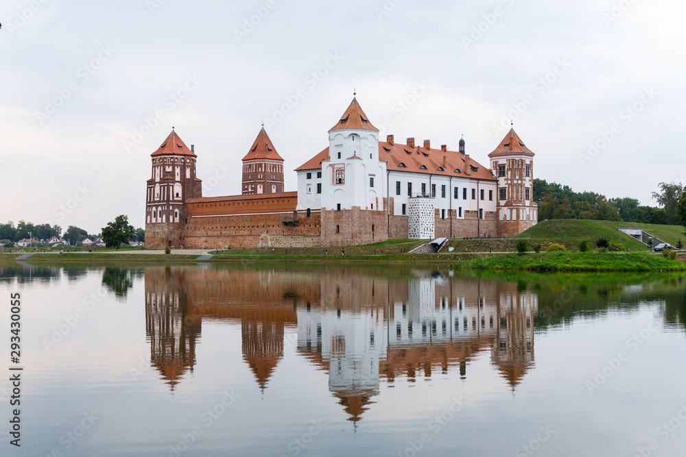 Mir Castle and its reflection in the lake in summer.