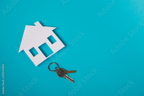Silver key with house figure