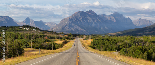 Beautiful View of Scenic Highway with American Rocky Mountain Landscape in the background during a Cloudy Summer Morning. Taken in St Mary, Montana, United States.