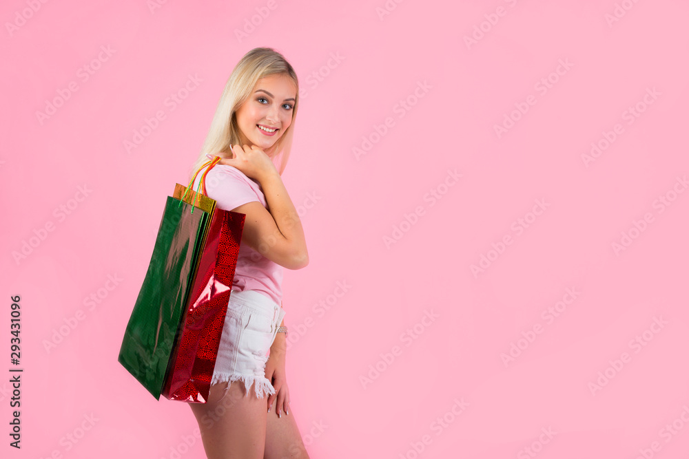 beautiful young woman on a pink background with packages in hands beautiful young woman on a pink background with packages in hands