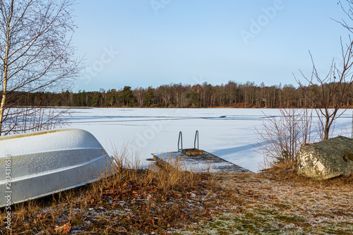 Jetty at a frozen lake with snow