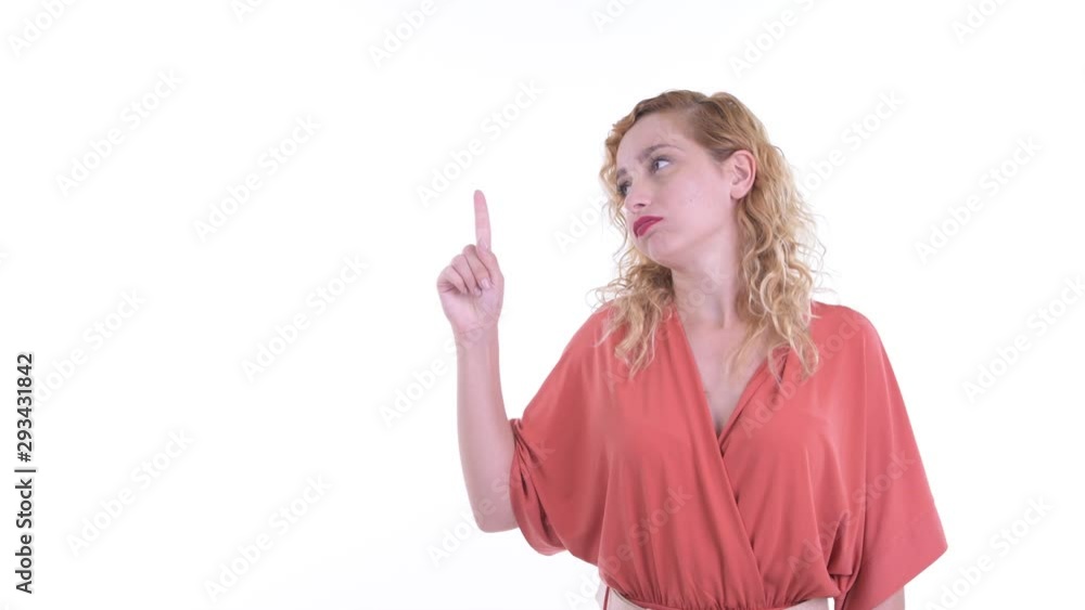Stressed blonde businesswoman pointing up and looking upset Stressed blonde businesswoman pointing up and looking upset