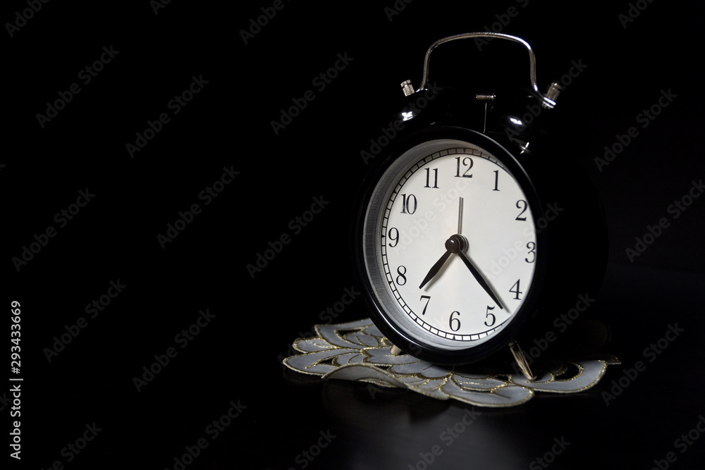 Classic mechanical alarm clock on dark background Classic mechanical alarm clock on dark background