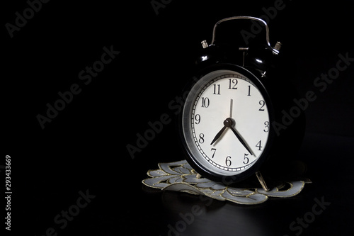 Classic mechanical alarm clock on dark background