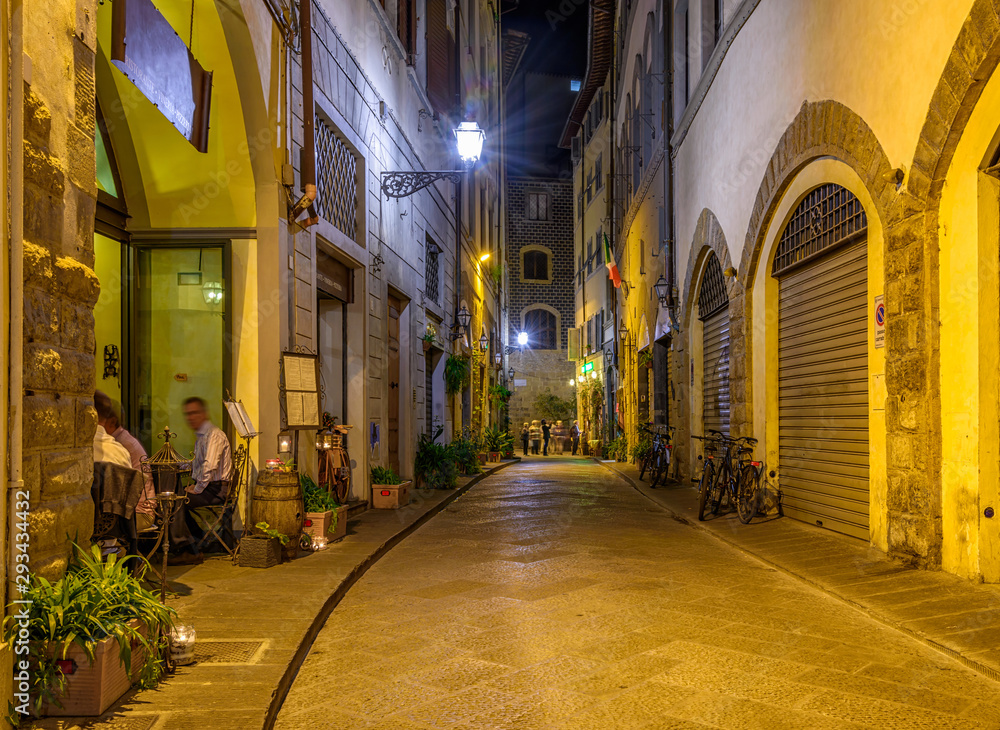 Night view of narrow street in Florence, Tuscany. Italy. Architecture and landmark of Florence. Night cozy cityscape of Florence