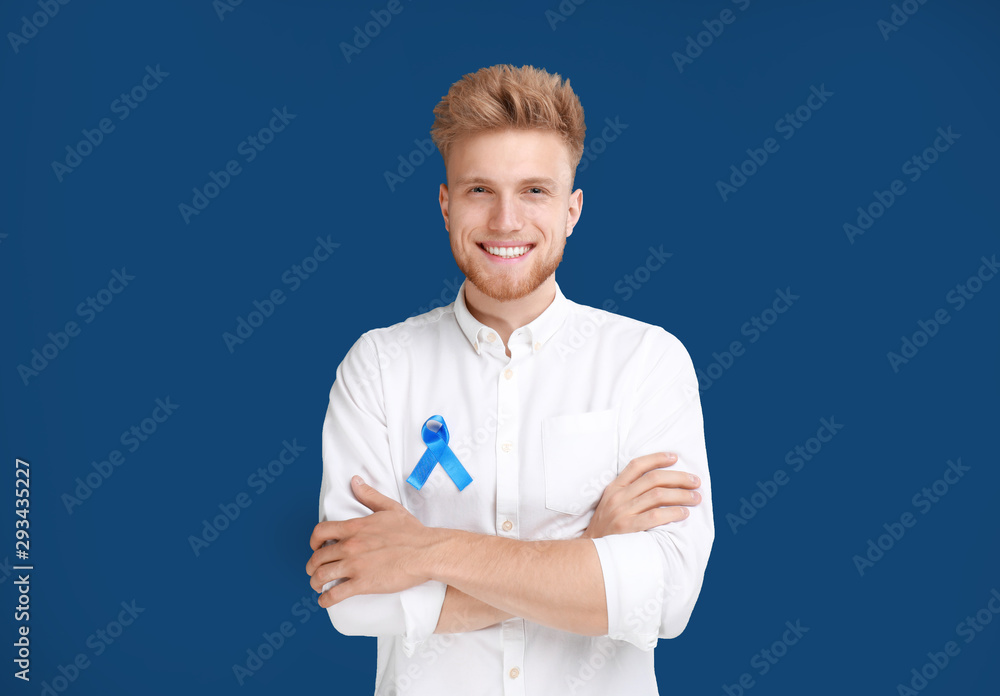 Young man with ribbon on blue background. Urology cancer awareness Young man with ribbon on blue background. Urology cancer awareness