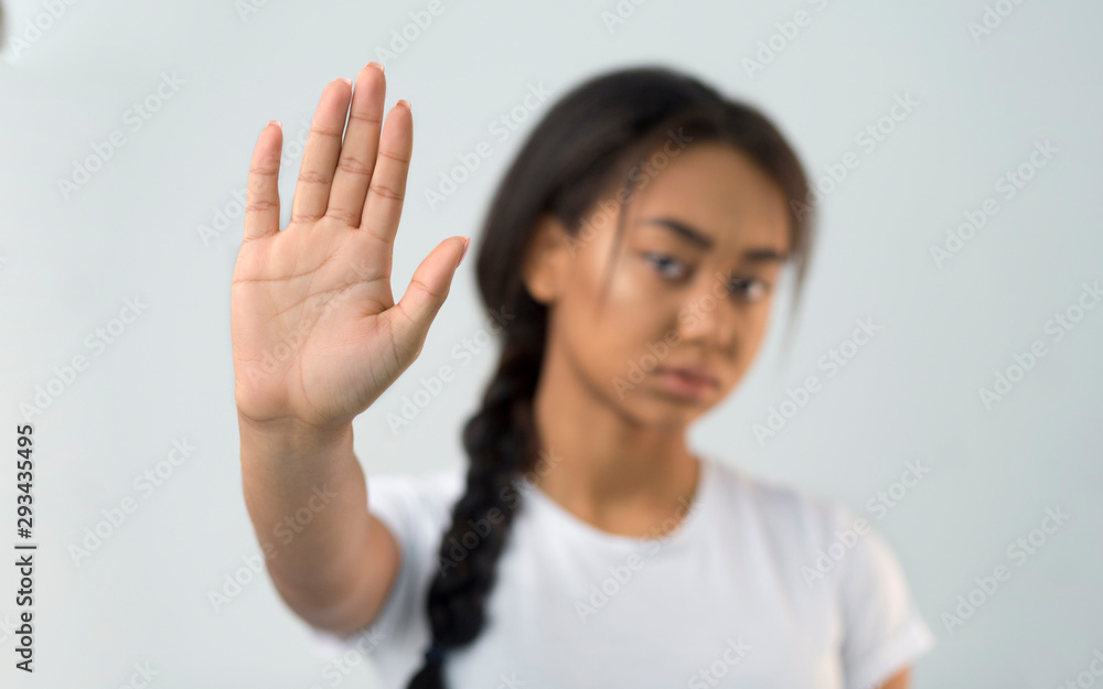 Asian girl making stop gesture with her palm Asian girl making stop gesture with her palm