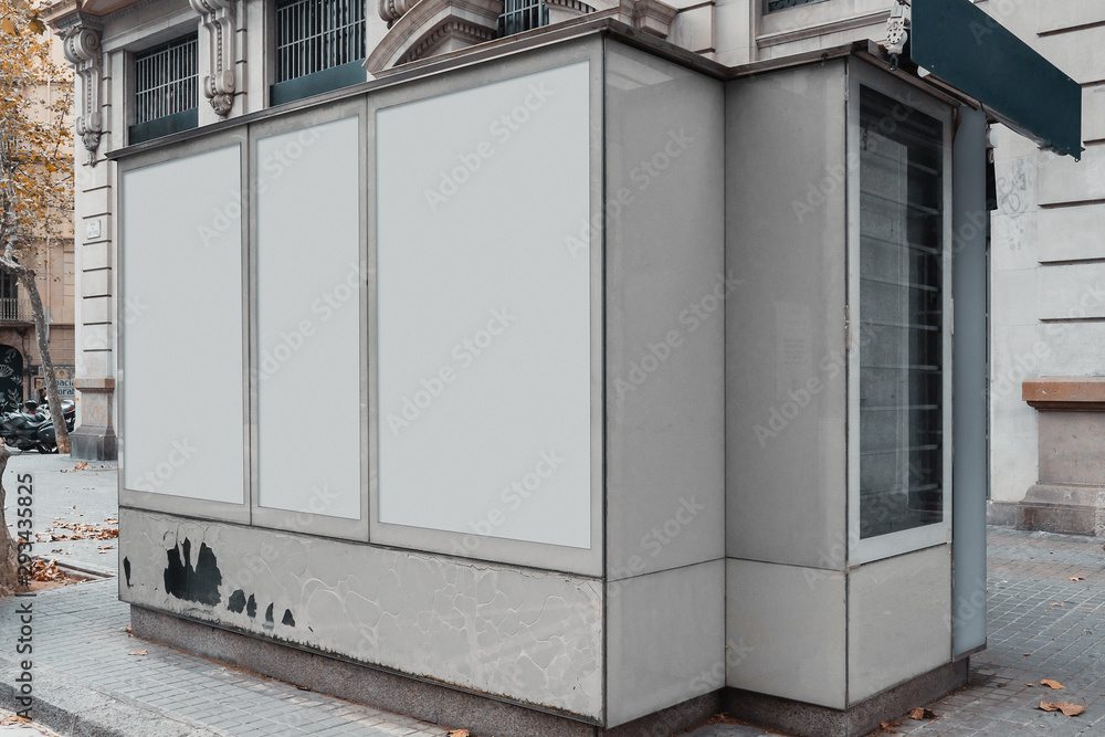 Blank canvas white outdoor banner at Newsstand with newspapers and magazines Blank canvas white outdoor banner at Newsstand with newspapers and magazines