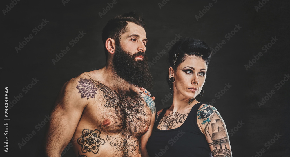 Pensive man and woman are posing for photographer at photo studio.