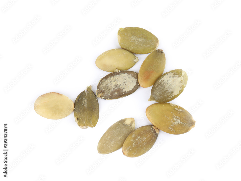 Obraz premium Raw peeled pumpkin seeds on white background, top view