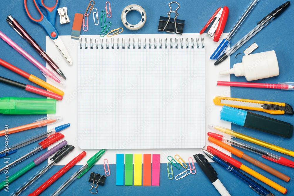 Stationery and blank notebook on blue background. Education concept with copy space for your ideas. Flat lay style. Stationery and blank notebook on blue background. Education concept with copy space for your ideas. Flat lay style.