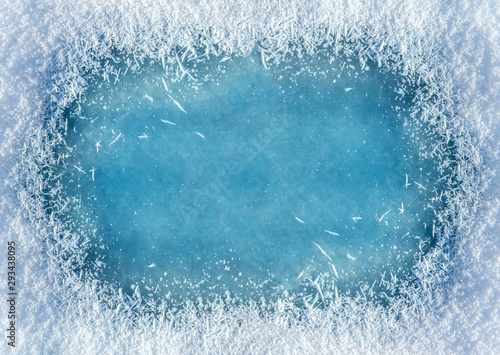 Winter background: close-up of frozen ice with snow crystals and snowflakes. Christmas and Happy New Year frame background with copyspace. Ice and snow texture photo